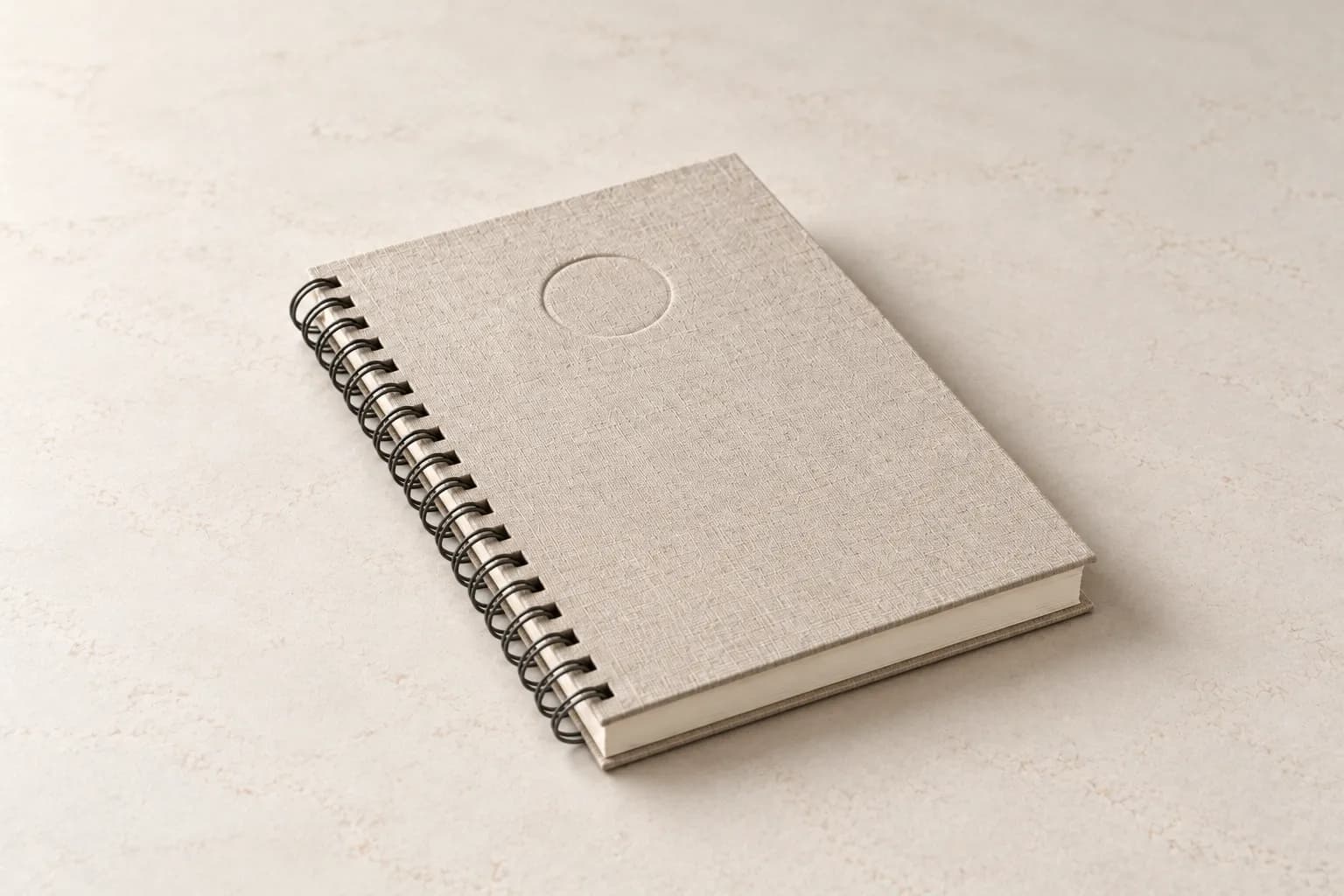 An OnSpot Roadbook, closed, on light stone.